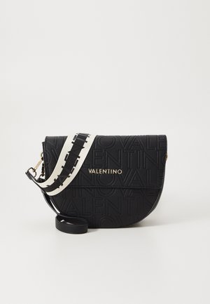 Black leather crossbody bag with debossed "Valentino" logo, curved shape, adjustable strap featuring black and white pattern, gold hardware accents.