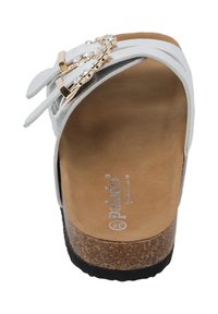 White platform sandal with two straps, jeweled accents, and a cork-like base. Soft textured footbed and black rubber outsole.
