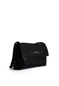 Black leather messenger bag with a flap closure, zippered main compartment, and front embellishment. Features an adjustable strap and sleek design.