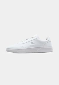 White sneaker with a smooth synthetic upper, flat laces, subtle perforations, and a textured sole. Features a small logo on the side.
