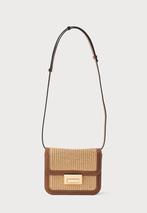 Rektangulær beige flettet crossbody taske med brun læderkant, gyldent rektangulært lås, og justerbar sort og brun skulderrem.