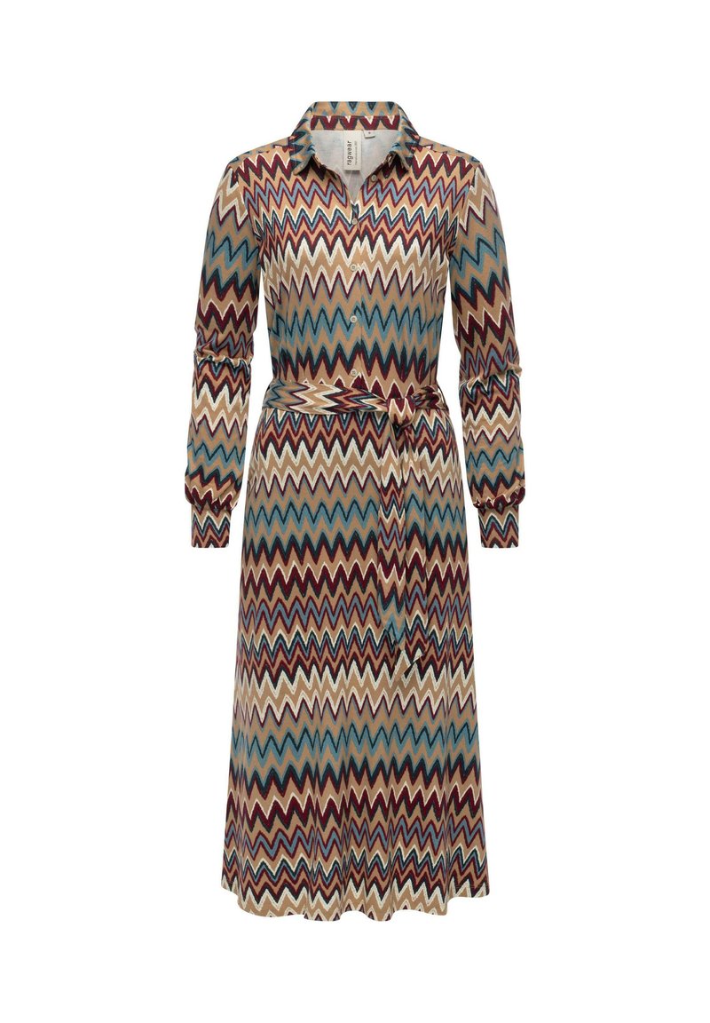 Sukienka w wzór z zygzakowatym motywem w kolorach czerwonym, niebieskim i kremowym. Długie rękawy, kołnierzyk, zapinana na guziki z przodu oraz pasek do wiązania w talii.