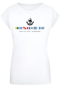 White cotton T-shirt with rolled sleeves. Front features a sailor graphic and maritime flags, text reading "Knut & Jan | Hamburg."