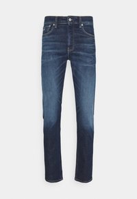 Mörkblå denimjeans med rak benpassform, utrustade med en traditionell 5-fickdesign, subtil blekning och mässingsdetaljer.