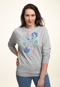 Šedá mikina s barevným motivem Stitch obklopeným tropickými vzory. Má žebrované manžety a lem.