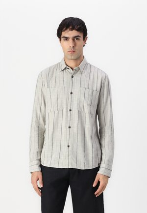 Light gray button-up shirt with vertical navy stripes, two chest pockets, long sleeves, and a classic collar. Soft, textured fabric.