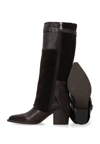 Hnědé kožené a semišové kozačky ke kolenům s masivním podpatkem, bočním zipem a dekorativním páskem s kovovými detaily. Texturované látkové panely.