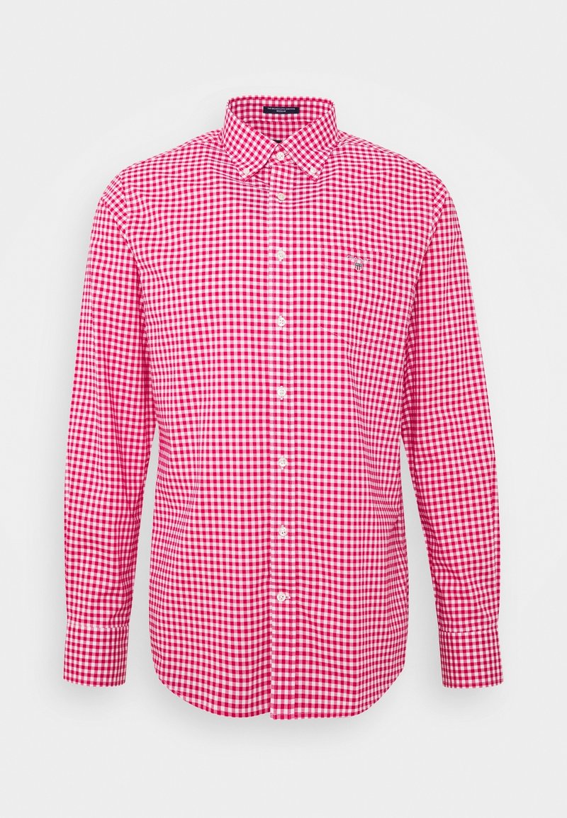 Chemise homme à manches longues avec boutons, motif vichy rouge et blanc, col pointu et petit logo brodé sur la poitrine gauche.