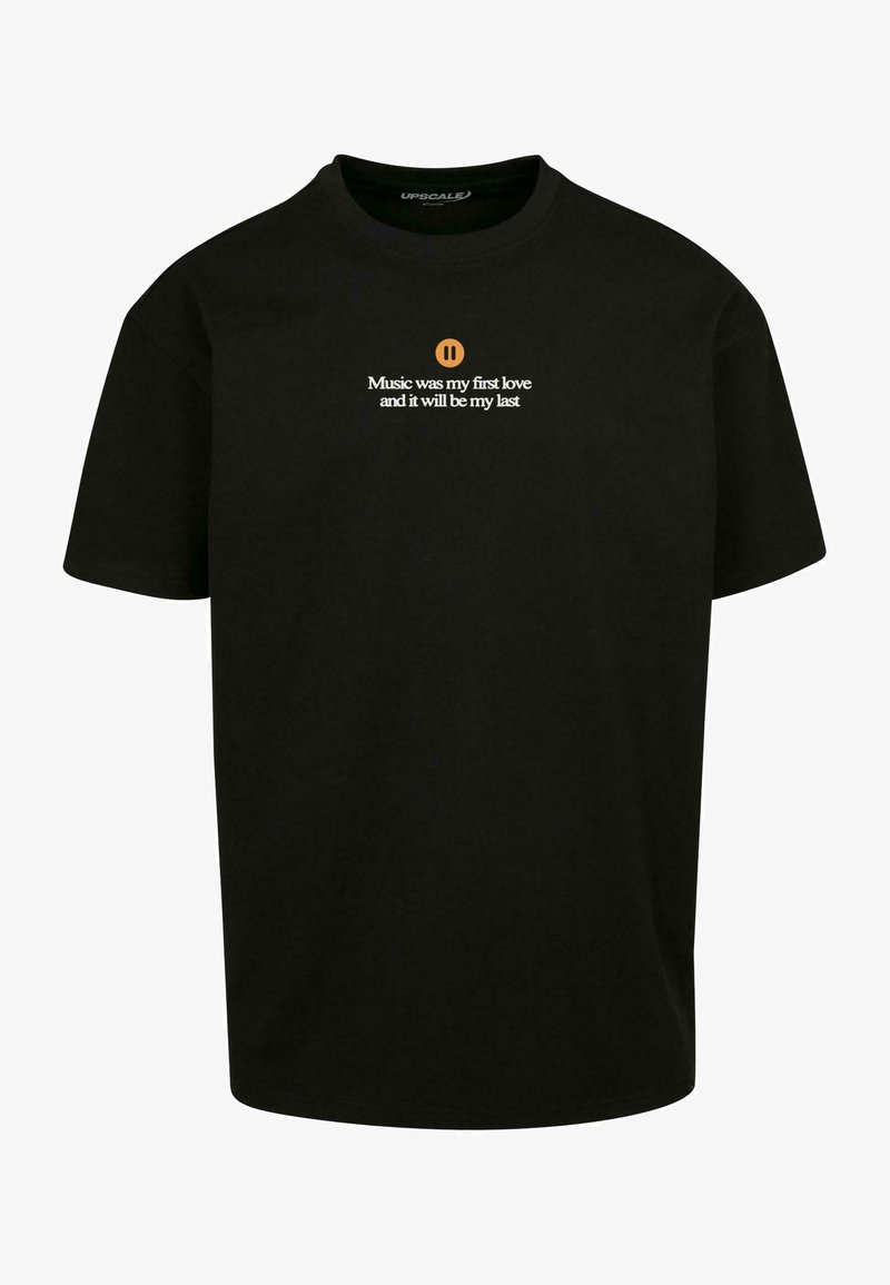 Black cotton t-shirt with short sleeves featuring white text and a pause symbol. Text reads: "Music was my first love and it will be my last."