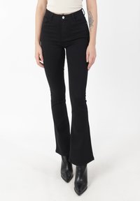 Jean noir évasé à taille haute, design à cinq poches, fermeture par bouton en métal, ajusté au niveau des cuisses et s'évasant au bas.