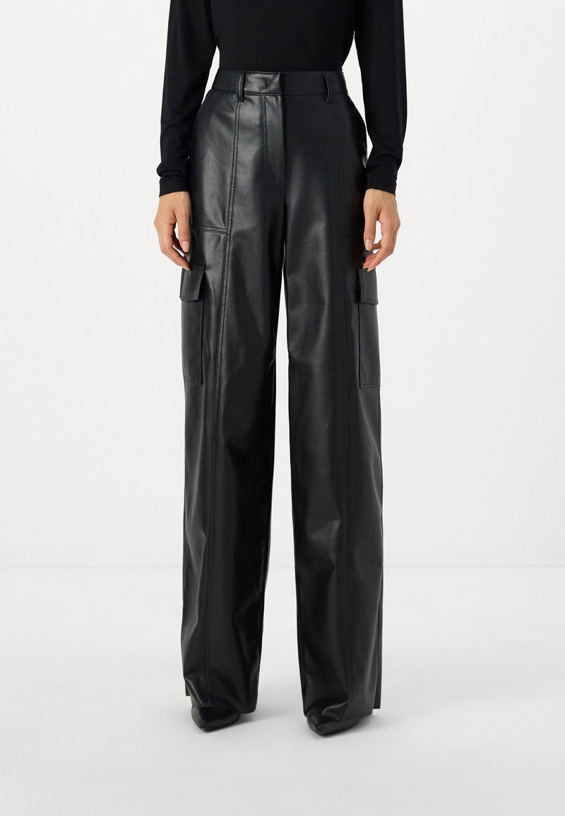Black leather cargo pants with a high waist, wide-leg fit, and external pockets. Smooth texture with subtle stitching details.