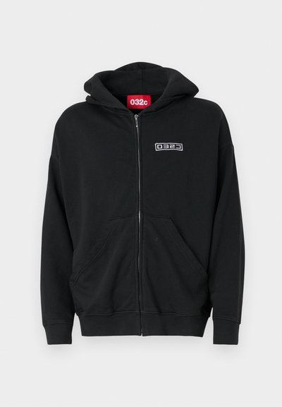 Black zip-up hoodie made of soft fabric with a front pouch pocket. Features a hood and an embroidered logo on the chest.