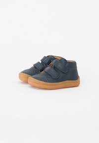 Dark blue leather shoes with two Velcro straps, rounded toe, and light brown rubber sole. Features stitched accents along the edges.