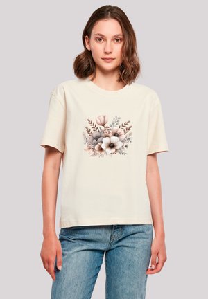 Cream short-sleeve t-shirt featuring a floral graphic design in soft pastel colors, set against a neutral background.