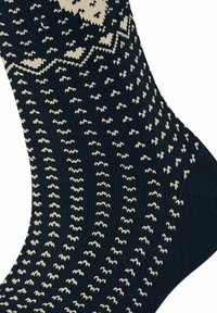 Granatowe skarpetki z dzianiny z kremowymi geometrycznymi wzorami, w tym zygzakami i falistymi liniami, z teksturowanym wzorem materiału.