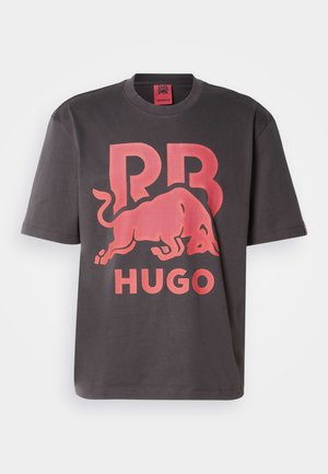 Dark gray cotton t-shirt featuring a large red logo with a bull and text “RR” and “HUGO” printed prominently. Short sleeves, crew neck design.