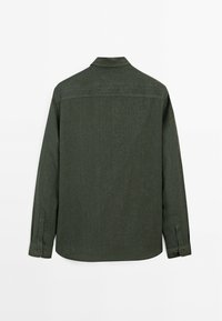 Dark green shirt, long sleeves, buttoned cuffs, collar, textured fabric, rear view, curved hemline, no patterns or visible hardware.