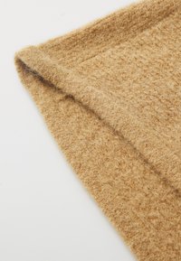 Camel-colored wool scarf with a soft, textured surface. Features a folded edge and a slightly fuzzy appearance.