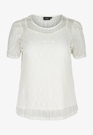Top in pizzo bianco con maniche corte, caratterizzato da pattern intricati, scollatura arrotondata e una texture leggermente trasparente. Etichetta del marchio visibile.