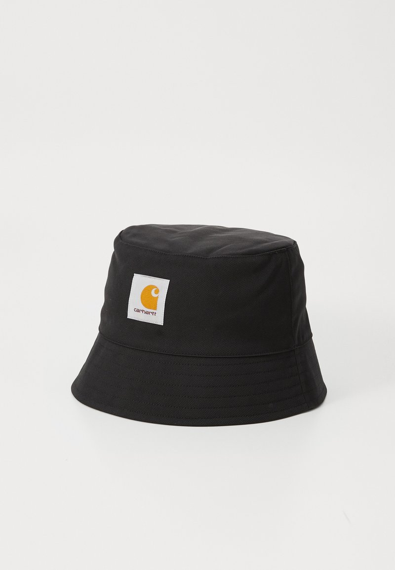 Black bucket hat made of durable fabric with a flat crown and wide, downward-sloping brim. Features a white patch logo with an orange emblem.