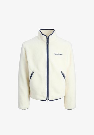 Giacca in pile bianco con colletto alto, zip blu e tasche laterali coordinate. Presenta un ricamo "Original Studio" sul petto.