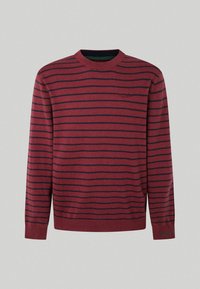 Röd och marinblå randig tröja med långa ärmar, rund hals, ribbade mudd och nederkant. Har en liten logotyp på bröstet. Mjuk textur.