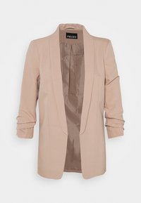 Blazer beige clair avec une texture lisse, design ajusté, devant ouvert et manches retroussées. Doublure intérieure visible. Étiquette de la marque : PIECES.