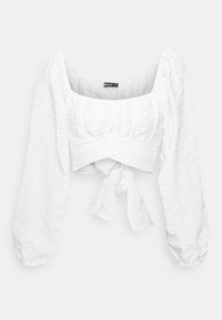 Top bianco corto con maniche lunghe e puff. Presenta un tessuto testurizzato con un design avvolgente e un nodo davanti. Scollatura quadrata.