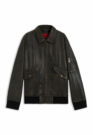 Leather bomber jacket in dark brown with a zip closure, two front pockets, ribbed cuffs, and a patch pocket on the sleeve. Textured finish.