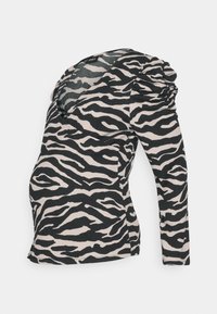 Haut de maternité à imprimé zèbre noir et beige, avec un décolleté en V, des manches longues et des détails froncés sur les épaules.