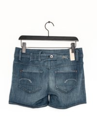 Denim shorts in dark blue, featuring a button front, belt loops, and two back pockets with small embroidered details. Hangs on a black hook.