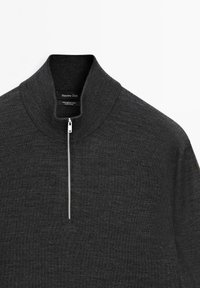 Dark gray merino wool quarter-zip sweater with a high collar and silver zipper. Soft texture with a minimalist design.