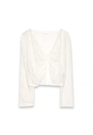 Crop top bianco in pizzo con maniche lunghe, motivo floreale e dettaglio arricciato alla profonda scollatura a V.