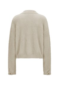 Beige langärmlige, cropped, fuzzy Jacke mit Kragen und geknöpften Manschetten, von hinten auf einem weißen Hintergrund gezeigt.