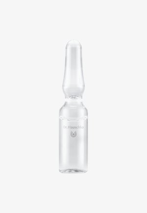 Petite ampoule en verre transparent à sommet arrondi, étiquetée "Dr. Hauschka", contenant un liquide transparent sur fond blanc.
