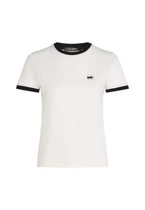 White cotton t-shirt with black ribbed neckline and sleeve hems. Features a small embroidered cartoon face design on the left chest.