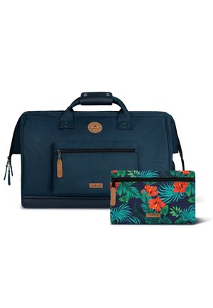 Large dark blue travel bag with front zip pocket and handle, accompanied by smaller zip pouch with green leaves and red flower pattern.