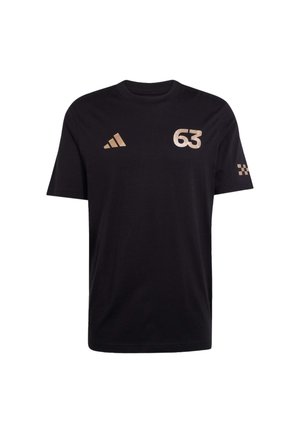 T-shirt en coton noir avec col rond, manches courtes, et impression dorée du nombre "63" ainsi que du logo Adidas sur la poitrine et la manche.