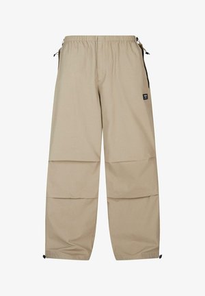 Bežīgas kravas bikses ar elastīgu jostu, sānu kabatām un regulējamiem aukliņām pie bikšu apakšas, kas izgatavotas no gludas, vieglas auduma.