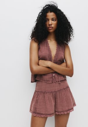 Lavender-hued cotton two-piece set featuring a sleeveless top with scalloped edges and matching tiered shorts with a ruffled hem.