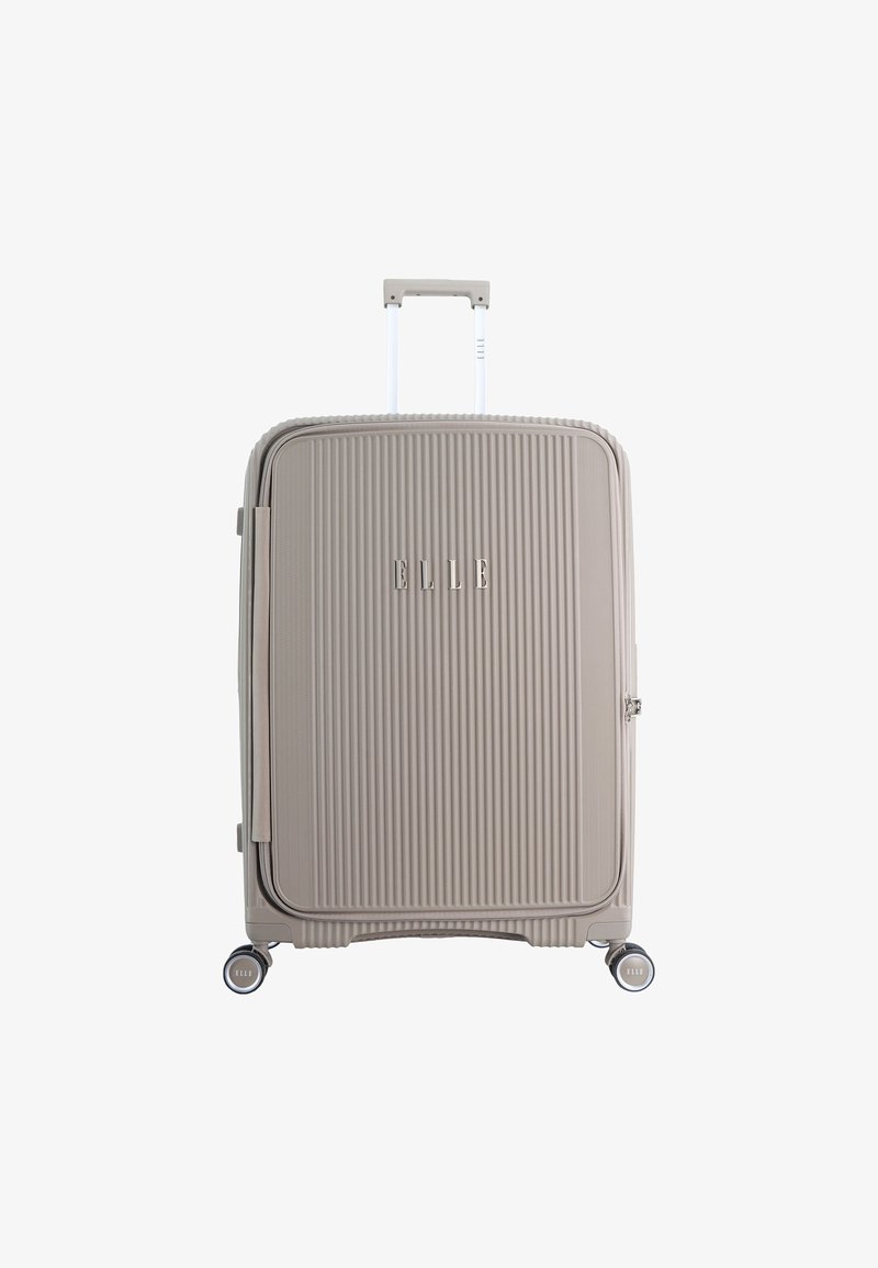 Hard-shell suitcase in light beige, featuring vertical ribbed texture, a retractable handle, four spinner wheels, and logo detail.