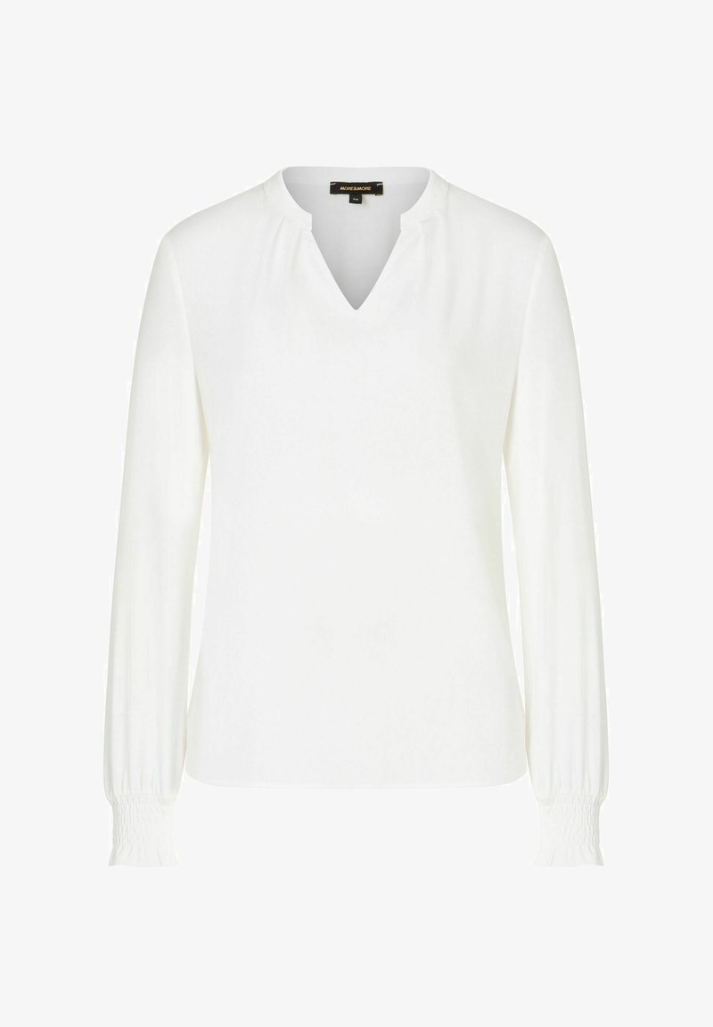 Weiße Bluse mit langen Ärmeln und V-Ausschnitt, weicher Textur und gerafften Manschetten. Enthält subtile Fältchen am Ausschnitt für zusätzliche Details.