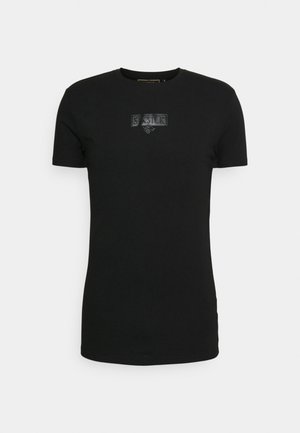 Schwarzes T-Shirt mit kurzen Ärmeln aus Baumwolle, mit einem strukturierten Logo-Patch in der Mitte. Rundhalsausschnitt, taillierter Schnitt und glatte Textur.