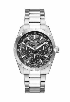Silver metal wristwatch with black tachymeter dial, three subdials, and white markers and hands showing 10:10:38 time.