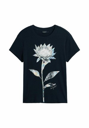 T-shirt noir à manches courtes avec un grand motif fleur métallique argentée et la signature « Desigual » au centre devant.