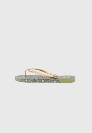 Thin gold-colored straps with a glitter finish on a flat sole featuring a blue floral pattern and green base. Designed as flip-flops.