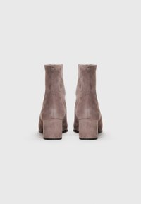 Grey suede ankle boots with a rounded toe and block heel, featuring a smooth texture and a minimalistic design without visible hardware.