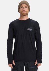 Zwart shirt met lange mouwen, gemaakt van zachte stof, met een ronde halslijn en een klein grijs logo op de linkerborst. Accentueert fitted mouwen.