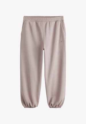Light beige sweatpants with elastic waistband and cuffs, side pockets, and small embroidered logo on the right thigh.