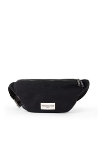 Black canvas fanny pack with zip closure, featuring a small brand label, adjustable strap, and a sleek, curved design.
